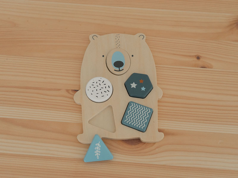 Jouet en boit en forme d'ourson avec des petites formes à encastrer façon puzzle.
